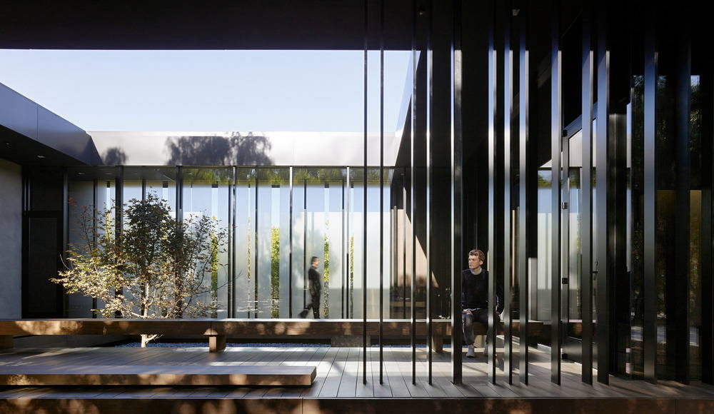 A glass enclosed bridge leads visitors to the northernmost gallery space while providing intimacy to the east facing courtyard : Photo credit © Matthew Millman