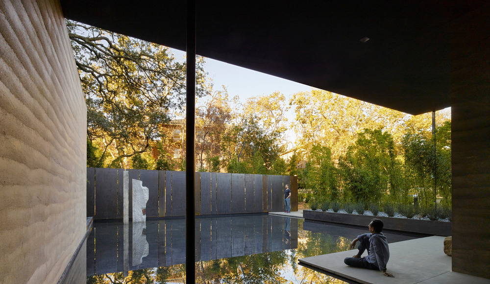 Water, in conjunction with landscape, is used throughout as an aid for contemplation; fountains within the main gallery and the courtyard provide ambient sound while a still reflecting pool to the south reflects the surrounding trees : Photo credit © Matthew Millman