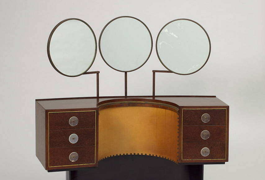 Designed by Gilbert Rohde (American, 1894 – 1944) Vanity Model 3920 Designed 1939 East Indian laurel, Sequoia burl, oak, acrylic, brass, patinated steel, leather, mirrored glass H x W x D: 127 × 127 × 43.2 cm (50 × 50 × 17 in.) Manufactured by Herman Miller Furniture Company (Zeeland, Michigan, USA) : Photo Matt Flynn © Smithsonian Institution