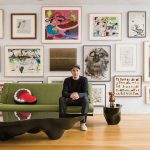 KAWS sitting in front of his extensive art collection : Photo by © Stefan-Ruiz