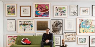 KAWS sitting in front of his extensive art collection : Photo by © Stefan-Ruiz