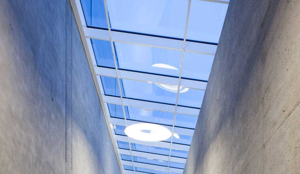 Light Fittings beneath a continuous roof light : Photo credit © Markus Kaiser