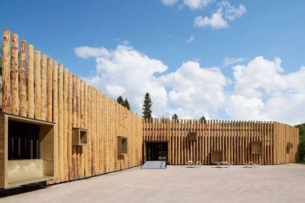 The protruding wooden boxes transform the building to an urban furniture : Photo credit © Åke E:son Lindman