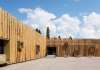 The protruding wooden boxes transform the building to an urban furniture : Photo credit © Åke E:son Lindman