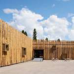 The protruding wooden boxes transform the building to an urban furniture : Photo credit © Åke E:son Lindman