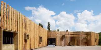 The protruding wooden boxes transform the building to an urban furniture : Photo credit © Åke E:son Lindman