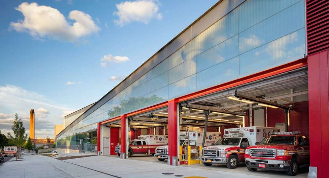The signature FDNY-red overhead garage doors punctuate the street façade : Photo credit © Paul Warchol