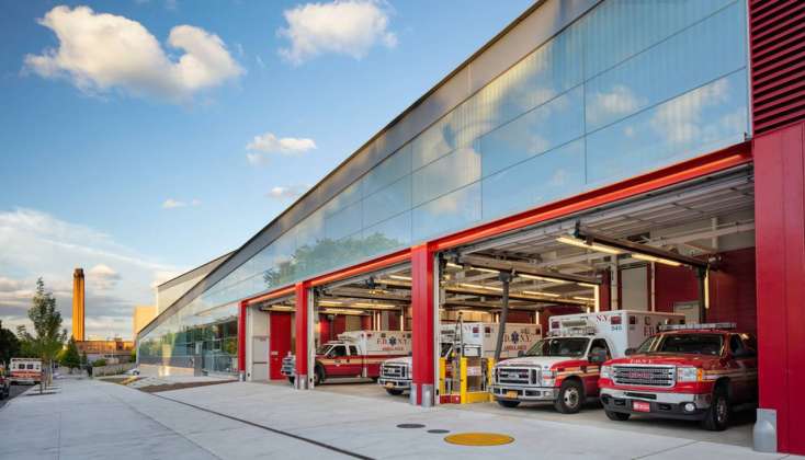 The signature FDNY-red overhead garage doors punctuate the street façade : Photo credit © Paul Warchol