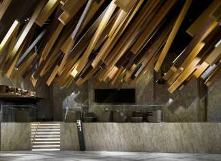 In the lobby, long rectangular-cuboid decorations extend from the ceiling, mimicking the motion of a meteor shower streaking through the sky : Photo credit © One Plus Partnership Limited & Jonathan Leijonhufvud