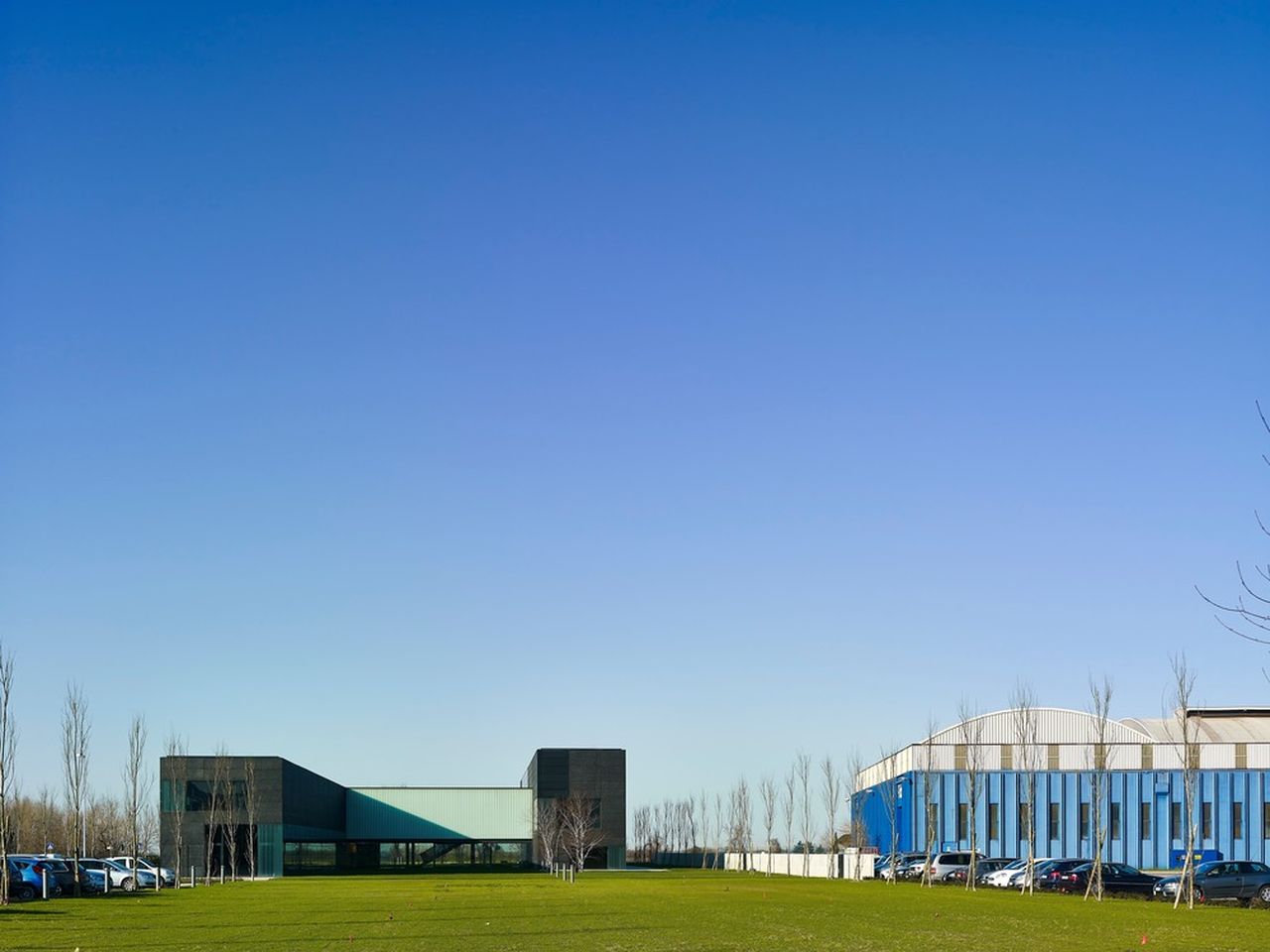 The building looks "small" compared to the surrounding industrial plants : Photo credit © Massimo Crivellari